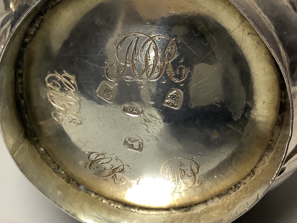 A George III silver hot water jug of wrythen baluster form